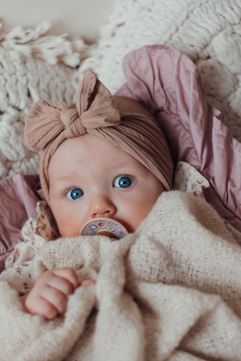 Waches Baby mit rosa Schleife